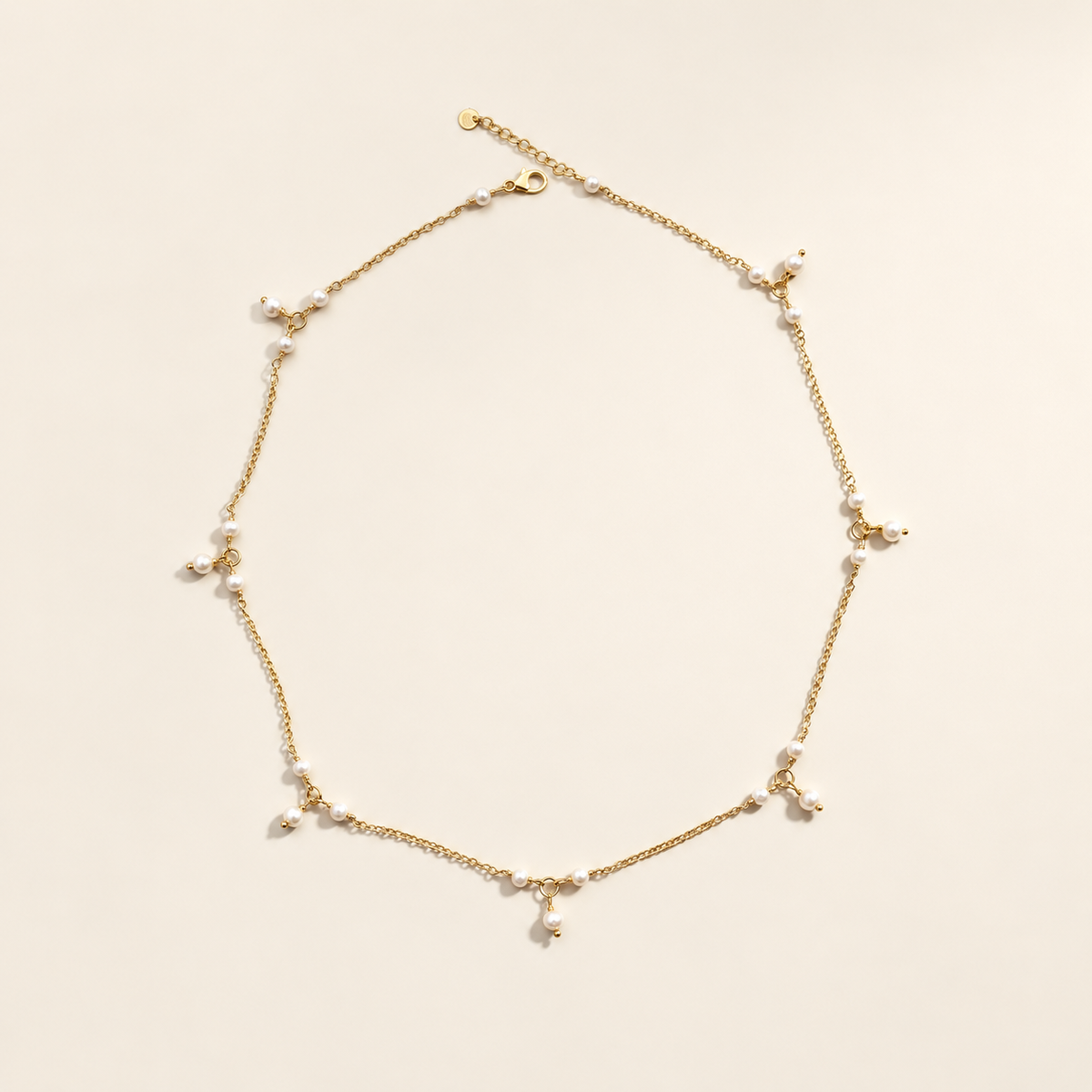 Anja Pearl Charm Necklace on warm ivory-beige background