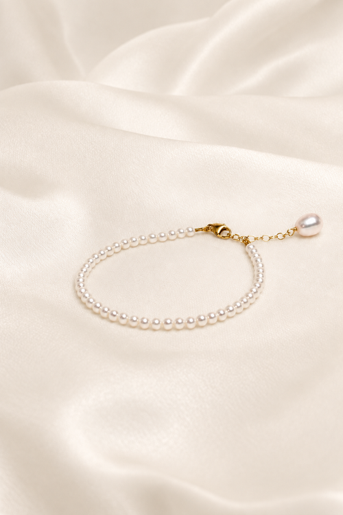 Céline Bridal Pearl Bracelet on warm ivory-beige background