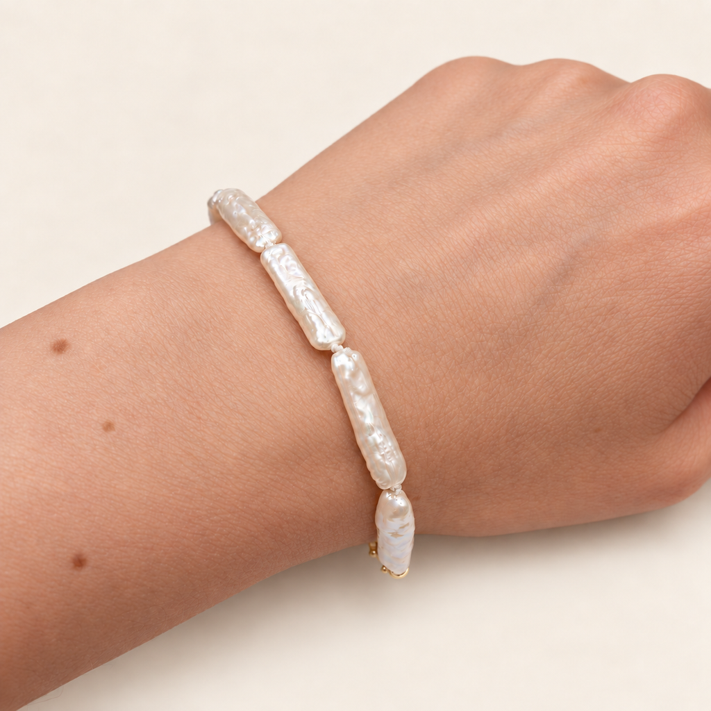 Fabienne Keshi Pearl Tennis bracelet in warm ivory on an elegant model hand