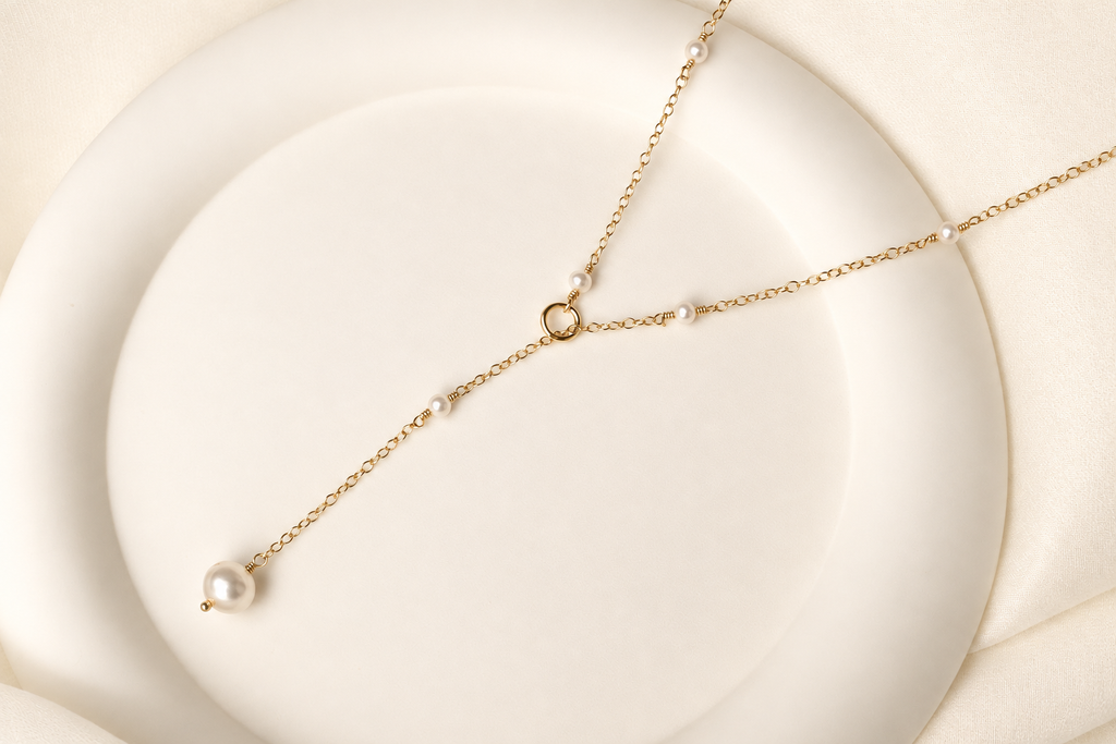 Lea Dainty Pearl Necklace on warm ivory-beige background