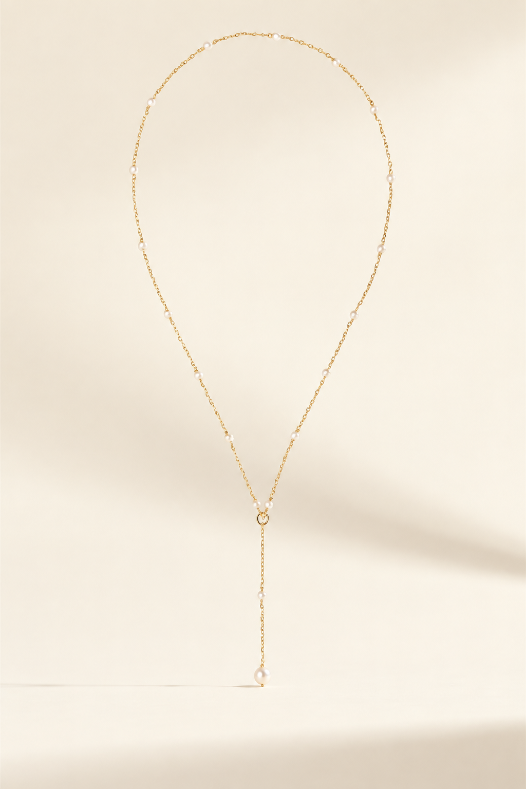 Lea Dainty Pearl Necklace on warm ivory-beige background