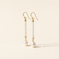 Ursina Pearl Drop Earrings on warm ivory-beige background